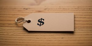Close-up of a price tag on a wooden surface.