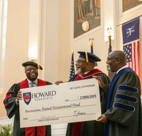 men standing in front of university with donation check; Gift Eases Shutdown