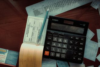 a calculator sitting on top of a wooden table; accounting software