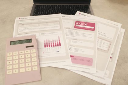 Bills, calculator, and a laptop: financial tasks underway.; Bookkeeping Basics