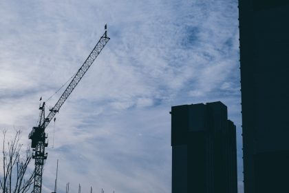 a crane is seen against a cloudy sky