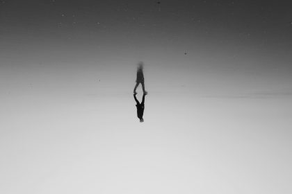 a person standing in the middle of a body of water; underpricing