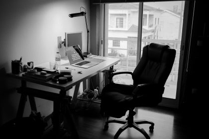 black office rolling chair near white wooden desk; freelance invoice