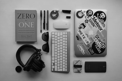 black corded headphones, silver MacBook, Apple wireless keyboard, and Apple Magic Mouse; Freelance Portfolio