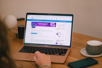 Someone is using a laptop, likely browsing social media.; LinkedIn Profile