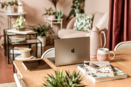 a wooden table topped with a laptop computer; Long-Term Self-Employment