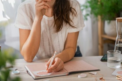 a woman writing to-do lists on a piece of paper