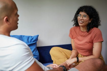 a man and a woman sitting on a couch; Peer Support
