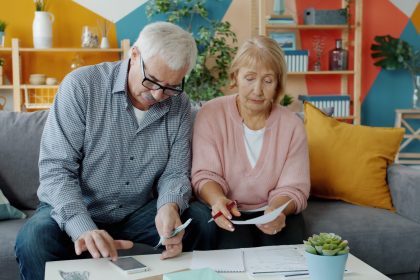 Elderly couple reviewing documents at home; Retirement Planning Options