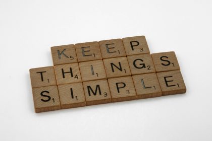 brown wooden blocks on white table; Simplify Your Business