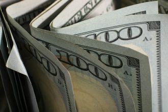 A close-up of us hundred dollar bills fanned out.; quick revenue without discounting