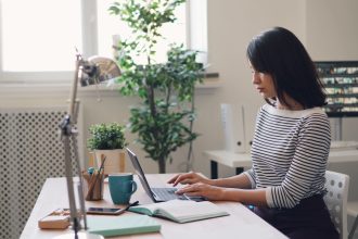 a woman sitting at a desk using a laptop computer; slow season routines