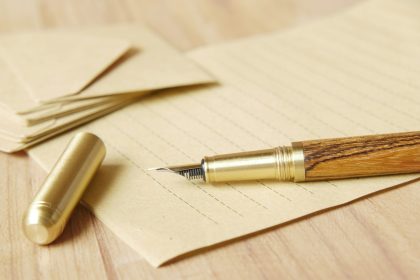 a pen and some papers on a table; redesign offers