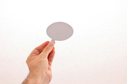 Photo of a hand holding a blank speech bubble, perfect for mockups and design concepts.; Master's in psychology