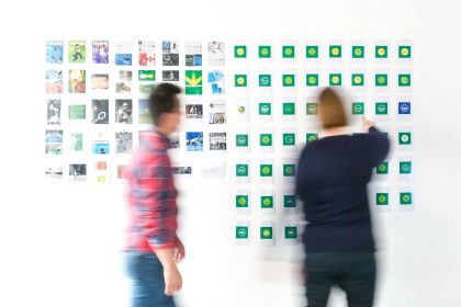 man in black long sleeve shirt standing beside woman in red and white plaid dress shirt; slow season