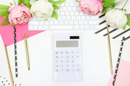 white calculator beside pink rose; bookkeeping for self-employed