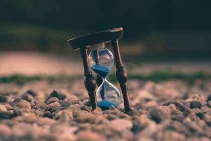 selective focus photo of brown and blue hourglass on stones; self-employed tax changes 2026