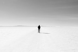 a person standing alone in the middle of a desert; slow seasons