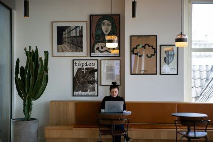 woman in black long sleeve shirt sitting on brown wooden chair; low quality client