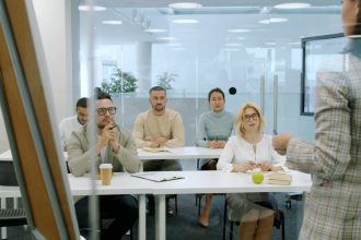 Business people attending a presentation in a modern office.; sales presentation strategy