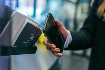 woman holding Android smartphone; free pay stub generator