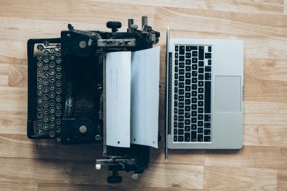 gray typewriter and MacBook; how much do freelance writers make