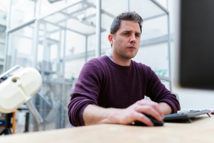 man in purple sweater sitting at the table; virtual business address