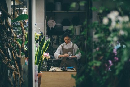 woman standing beside the table; does a sole proprietor need an ein