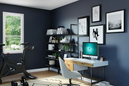 black flat screen computer monitor on brown wooden desk; home office deduction