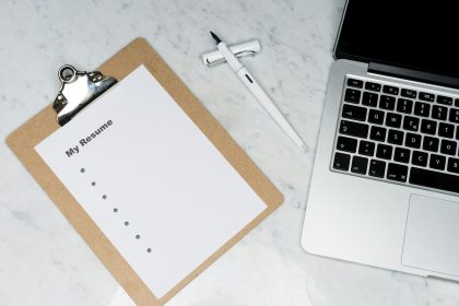 white printer paper beside silver laptop computer; how to put freelance work on resume