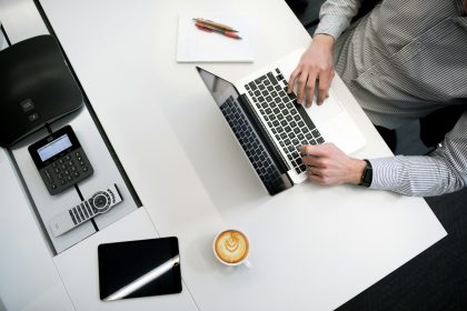 person using laptop on white wooden table; can i pay estimated taxes all at once