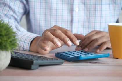 person using black computer keyboard; best payroll software