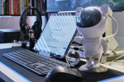 a robot standing next to a laptop; AI assistant