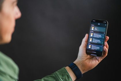 Man holding smartphone with app interface; AI freelance platforms 2026