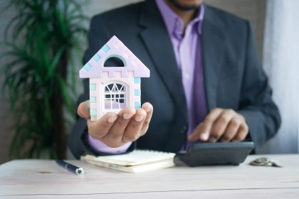 man in purple suit jacket using laptop computer; mortgage lenders for self-employed