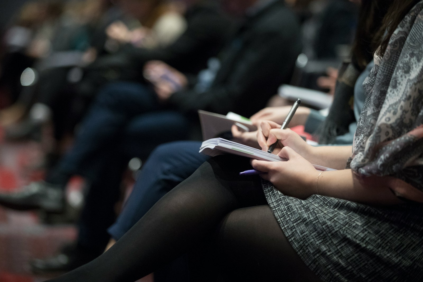 selective focus photography of people sitting on chairs while writing on notebooks; DOL joint employer rule