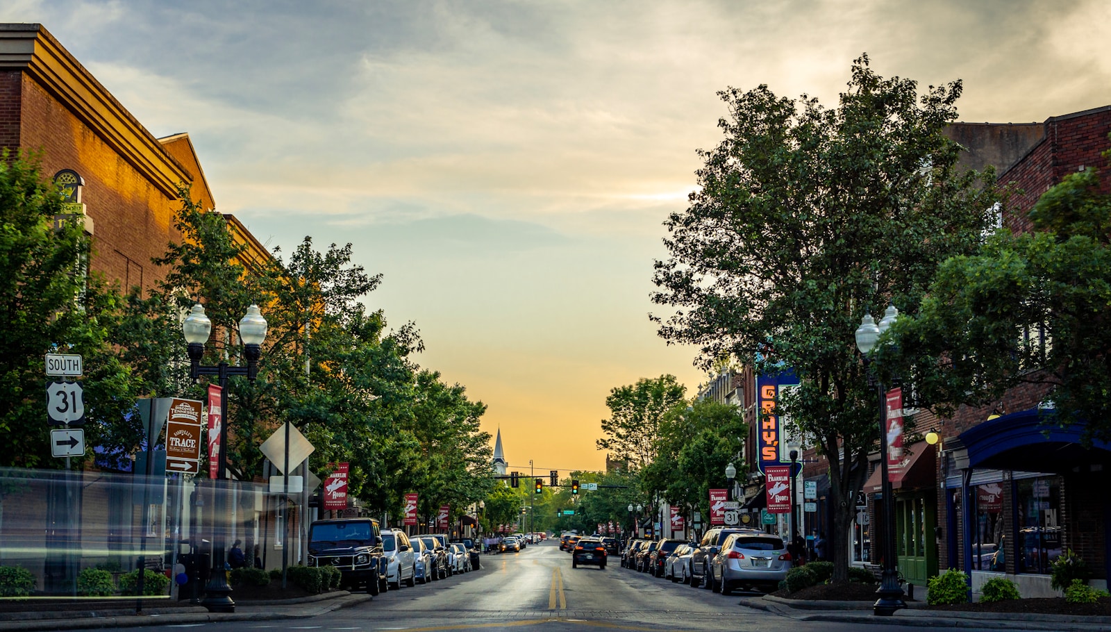 landscape photography of vehicles parked on side of a street; State of Main Street 2026