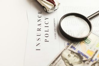 a magnifying glass sitting on top of a piece of paper; business insurance packages