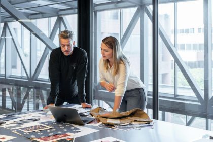 man and woman sitting at table; sustainable business navigator