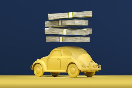 a yellow car with stacks of money on top of it; auto loans