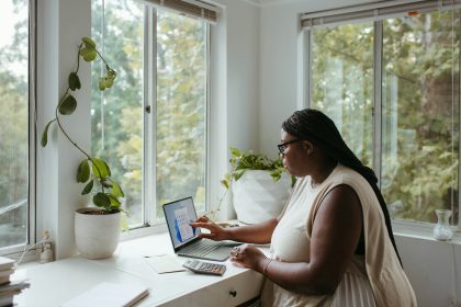 a woman sitting at a table with a laptop; what is form 8829
