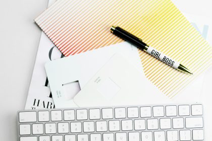 Apple Magic Keyboard, papers, and pen on white surface; business formation report