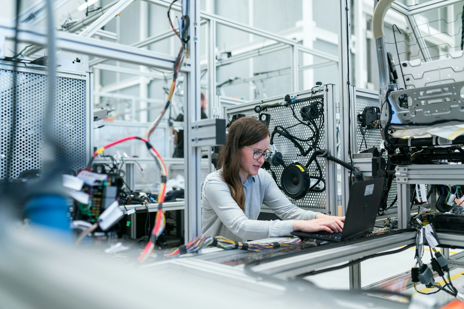 woman in white long sleeve shirt using black laptop computer; SBA Manufacturing grant