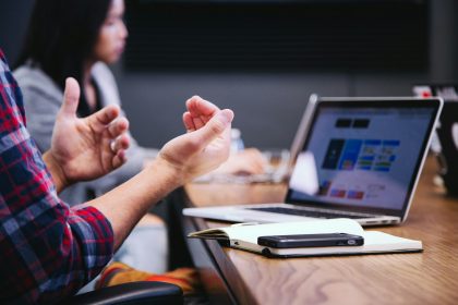 person gesturing during meeting with laptop; invoice vs receipt