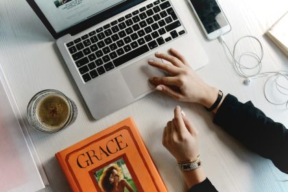 person typing on MacBook Pro keys; freelance marketing consultant
