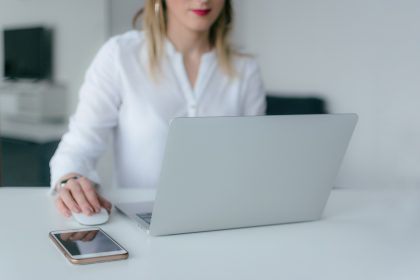 woman sitting and using MacBook Air and Apple Magic mouse; change order