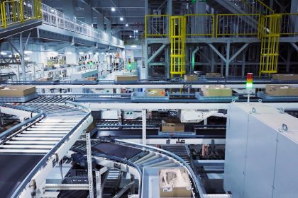 a factory filled with lots of machines and boxes; Empire State Manufacturing Survey