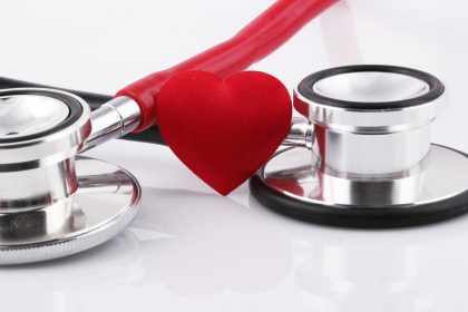a stethoscope with a red heart on top of it; health insurance plans