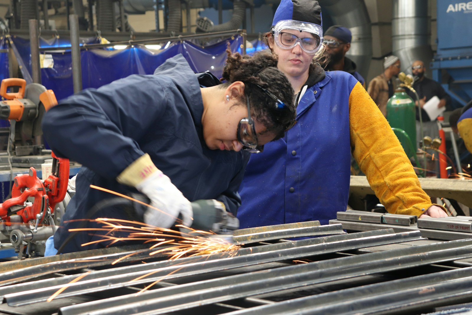 man in blue long sleeve shirt and blue vest; Philadelphia Fed manufacturing index