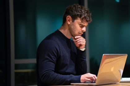 man in black long sleeve shirt sitting in front of macbook; May retail sales 2026